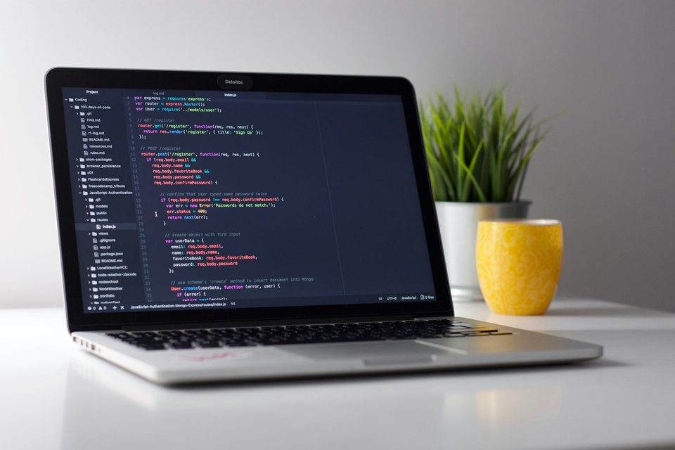 Laptop with web application code on screen